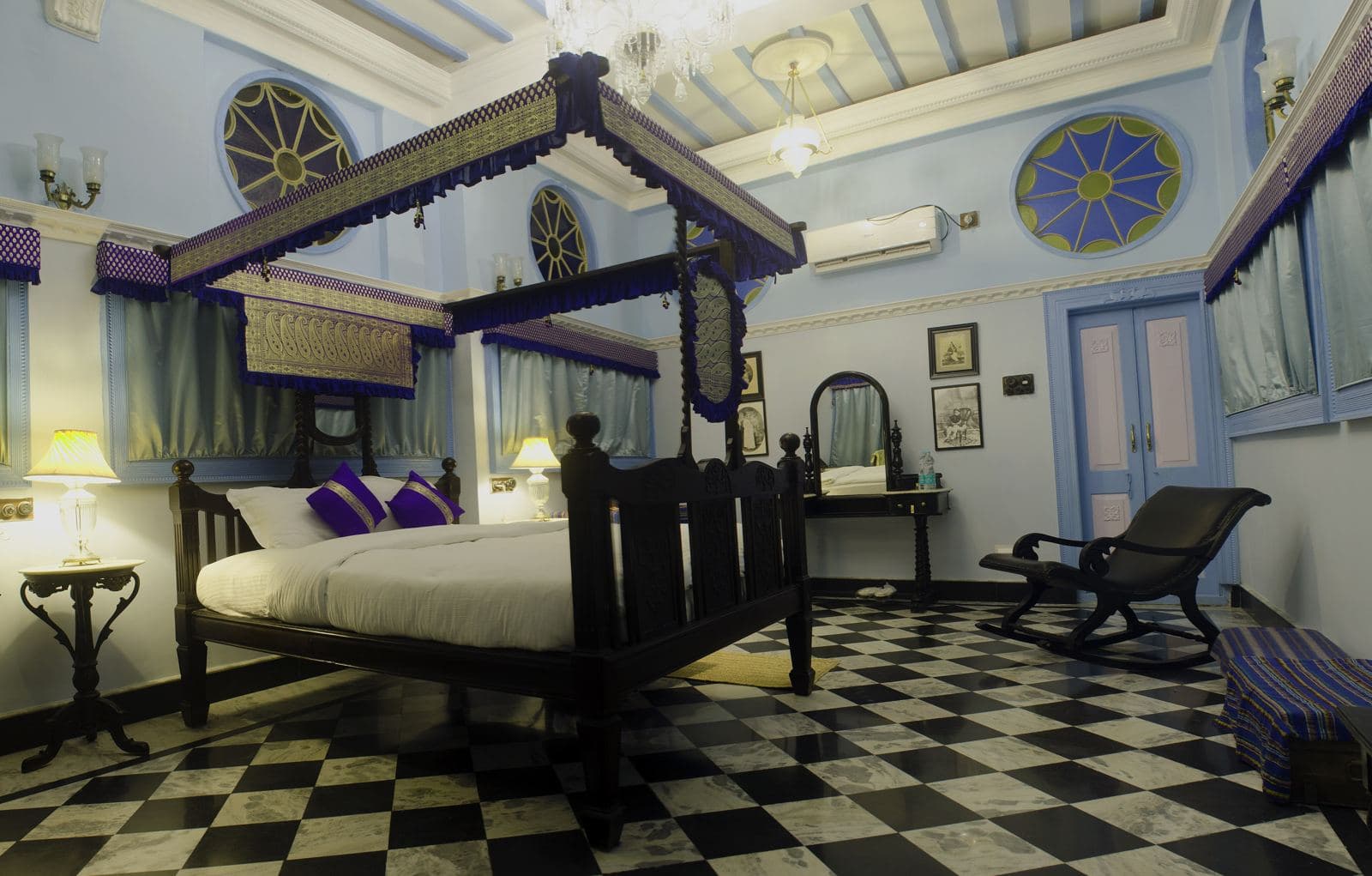Heritage hotel room with a four-poster bed and chequered floor